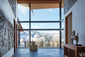 Stunning mountain views frame an Anselm Kiefer sculpture in the entrance gallery of the retreat architect Peter Marino designed for himself and his wife, Jane Trapnell Marino; the paintings are also by Kiefer. A Han-dynasty terra-cotta horse tops an antique Japanese tansu.
