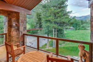 The covered porch offers views of the river.