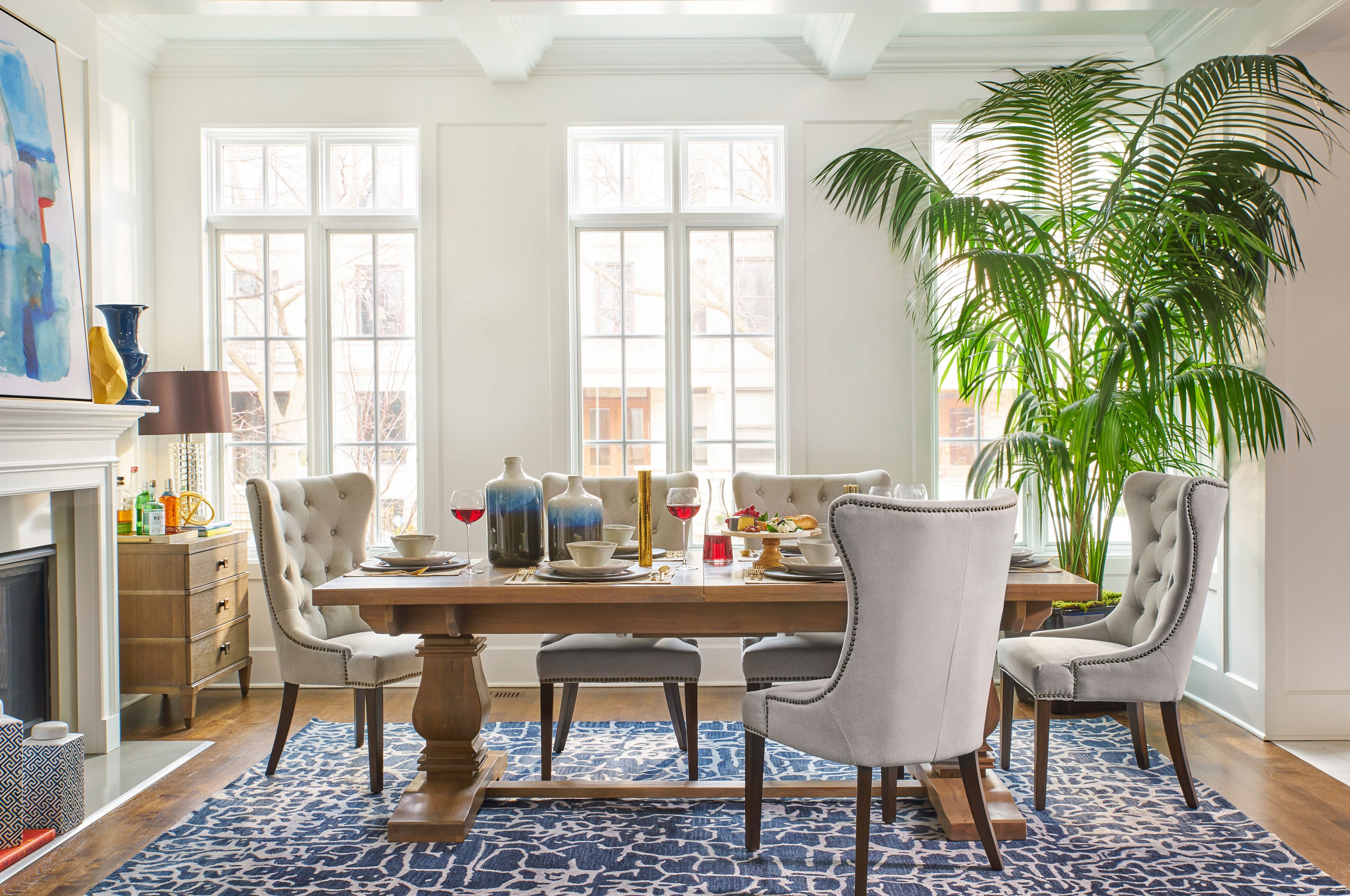 “For a more casual vibe, choose a lighter finish for your dining table and pair it with soft upholstered chairs and a bright patterned rug. I like to accessorize the dining room table and incorporate plants or flowers. As a result, your dining room will look less stuffy and more lived in—in a good way.”