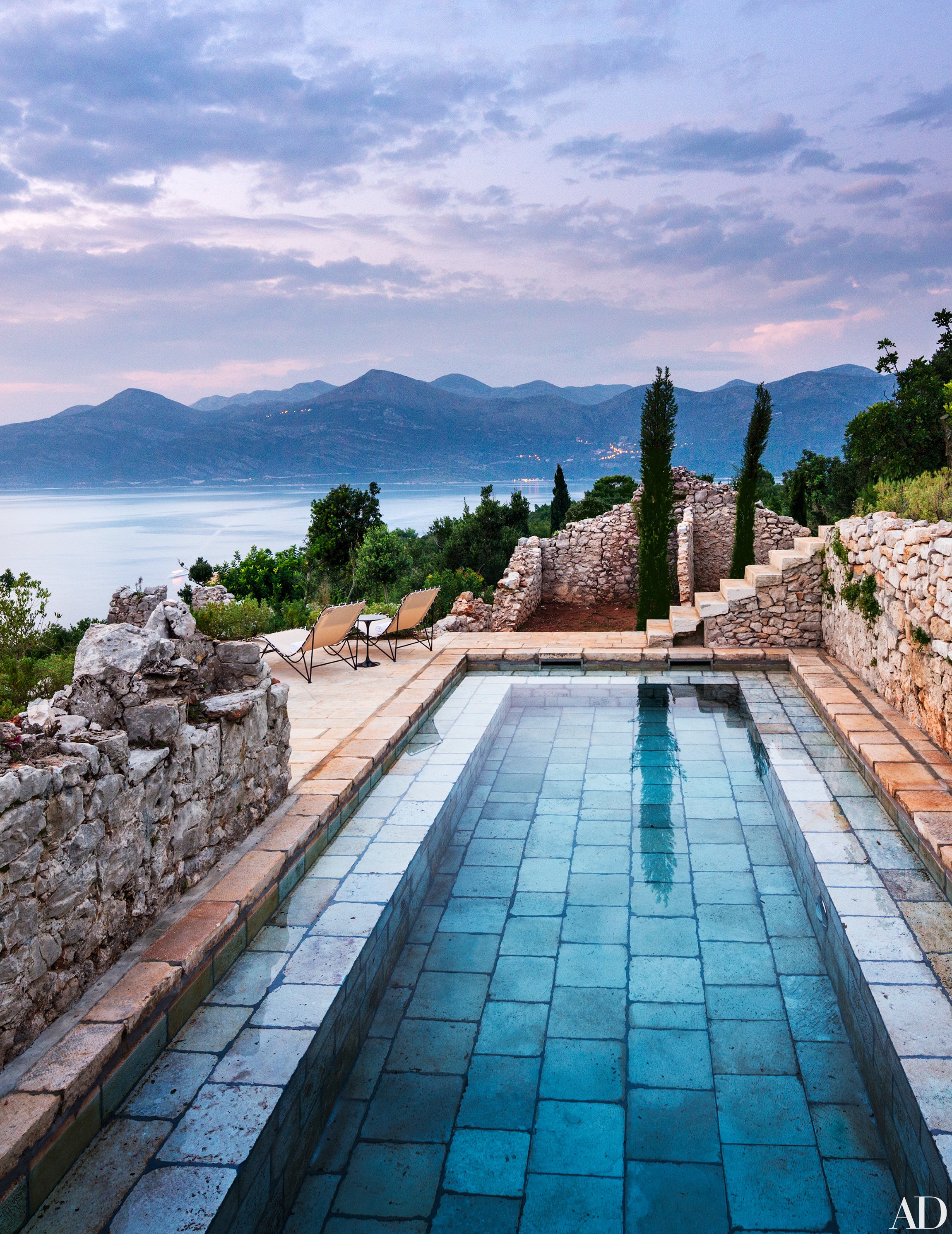On a Croatian island in the Adriatic Sea, a stone-paved pool by David Kelly of Rees Roberts + Partners melds seamlessly with the property’s centuries-old walls.