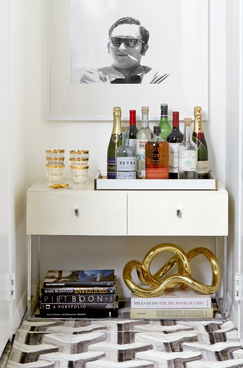 In a nook between the closet and bath, Obeid installed a bar area that’s topped with a framed image of his late father. “It’s the perfect place to raise a glass to him,” says Obeid.